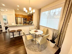 Open-concept layout with elegant dining area and kitchen bar seating