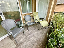 Covered balcony seating area (living room + primary suite access)