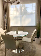 High-end leather dining chairs paired with a modern glass table